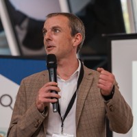 man wearing green crew-neck top and eyeglasses with black frames looking at side