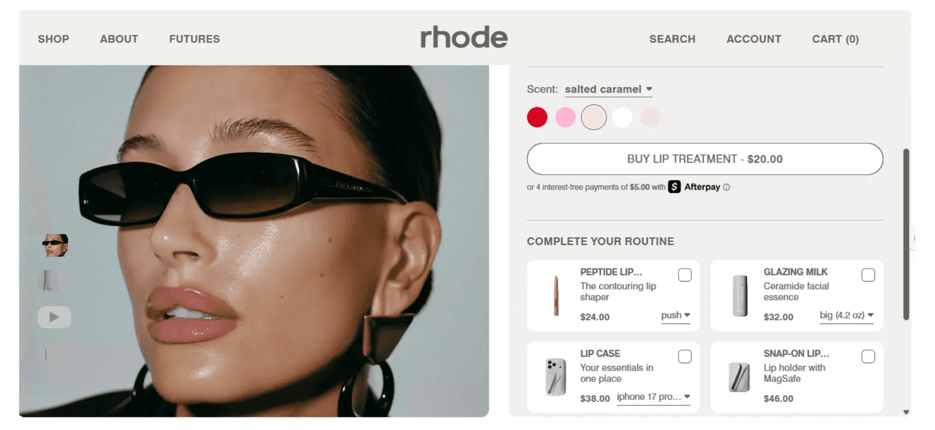 Hailey Bieber wearing Rhode Peptide Lip Treatment salted caramel and black sunglasses.