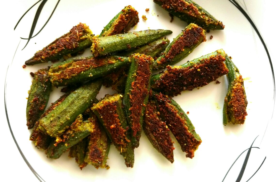 Bharli bhendi or stuffed okras stuffed with a spicy coconut-peanut filling served in a plate