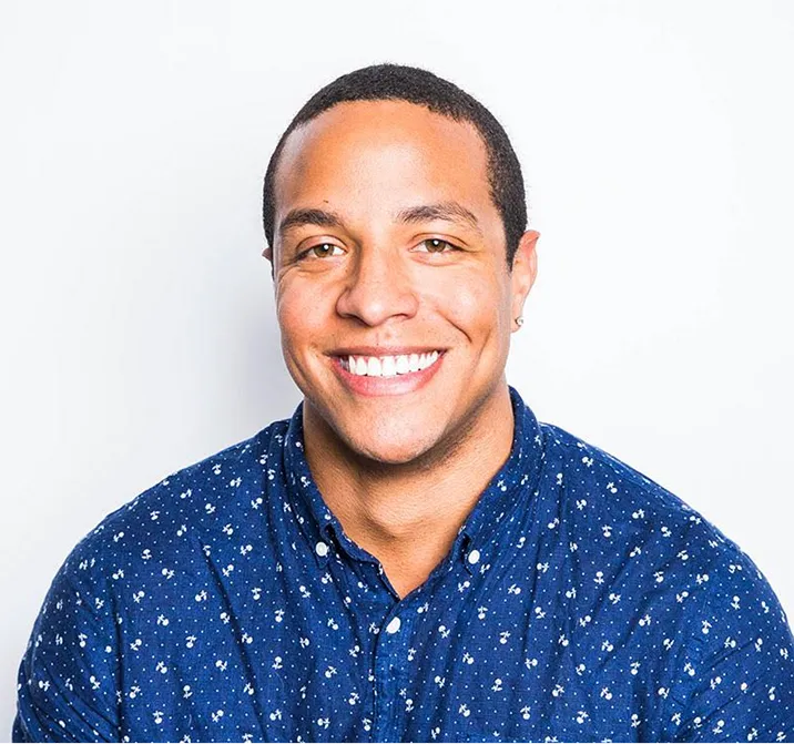 A portrait of a young man smiling in a blue shirt