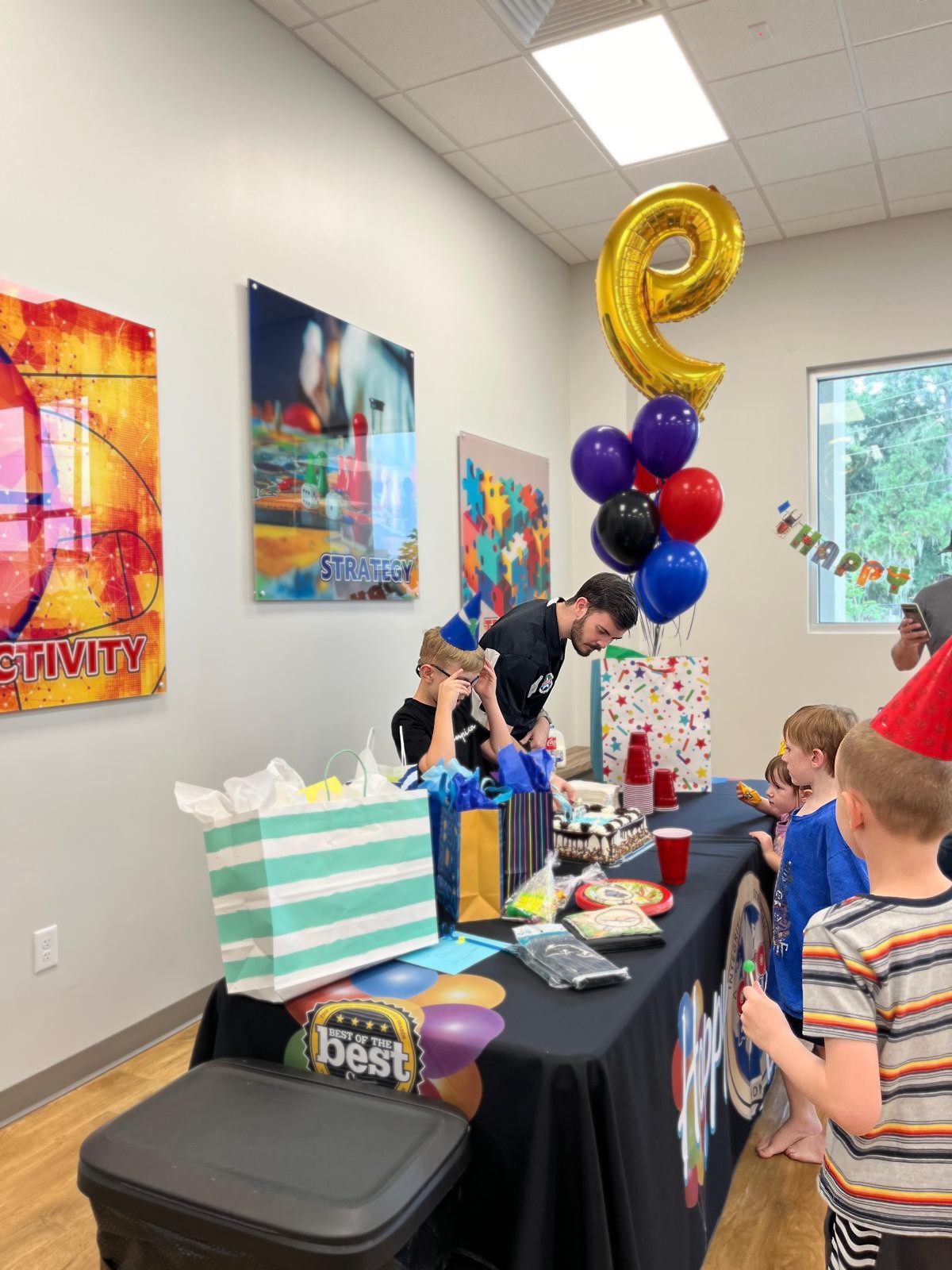 Okito team member helping a child cut their cake.