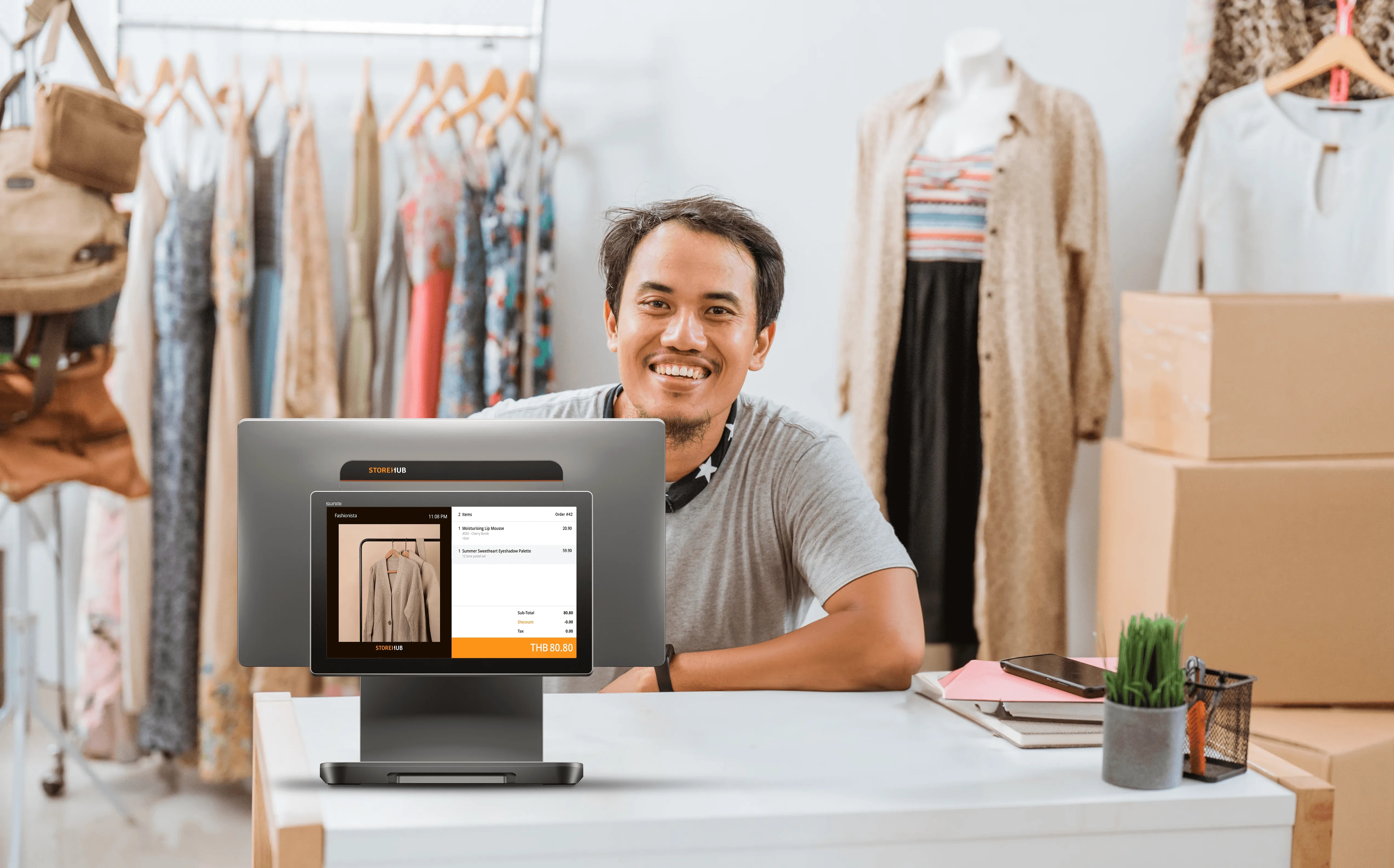 Retail business owner using the StoreHub cloud POS system for inventory management and sales reporting.