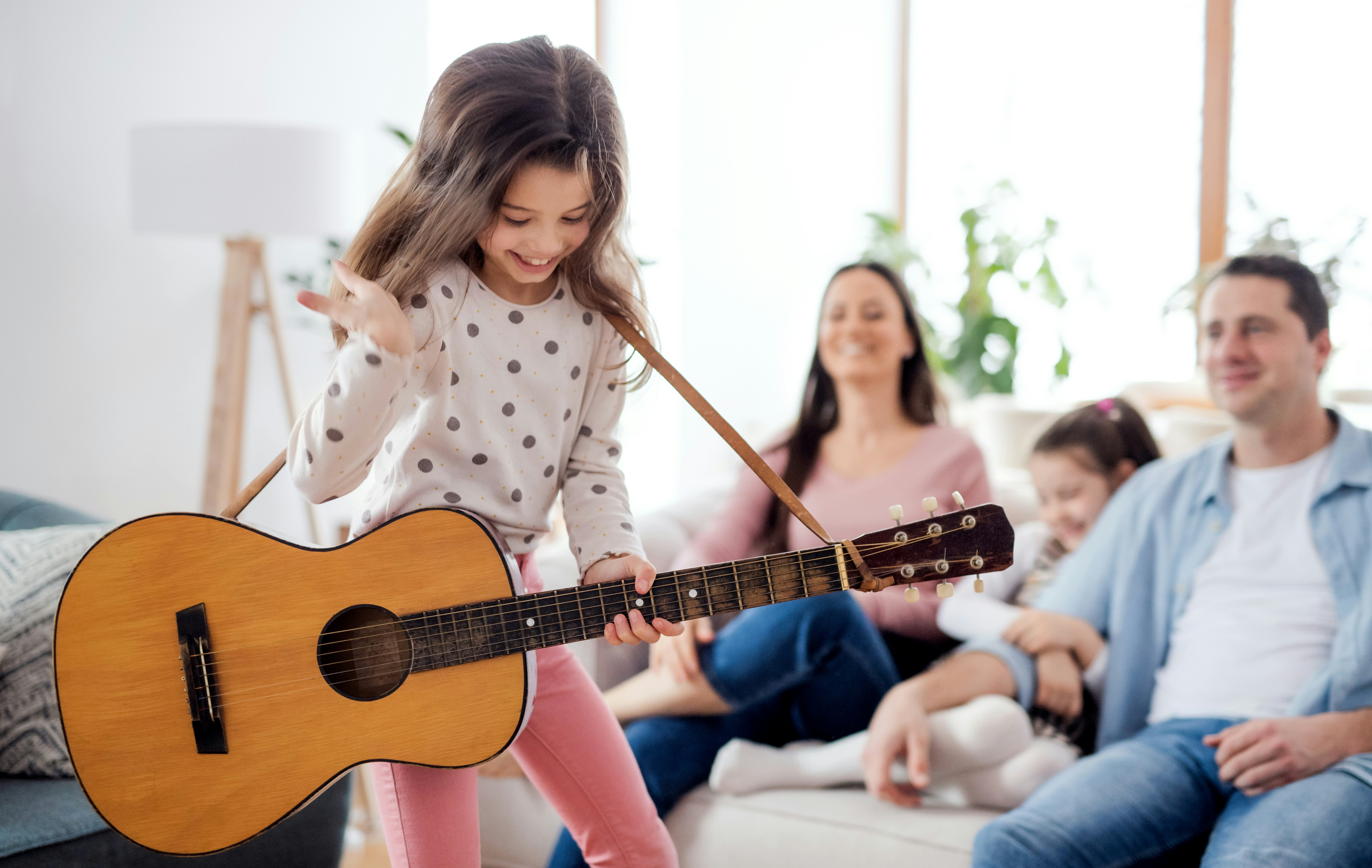 Comparison of bored child with boring songs vs excited child playing favorite music on guitar
