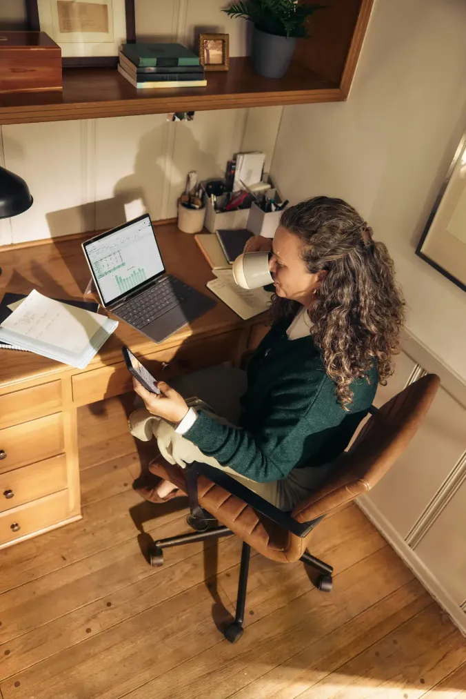 A woman meeting online at her laptop during a healing session over Zoom.