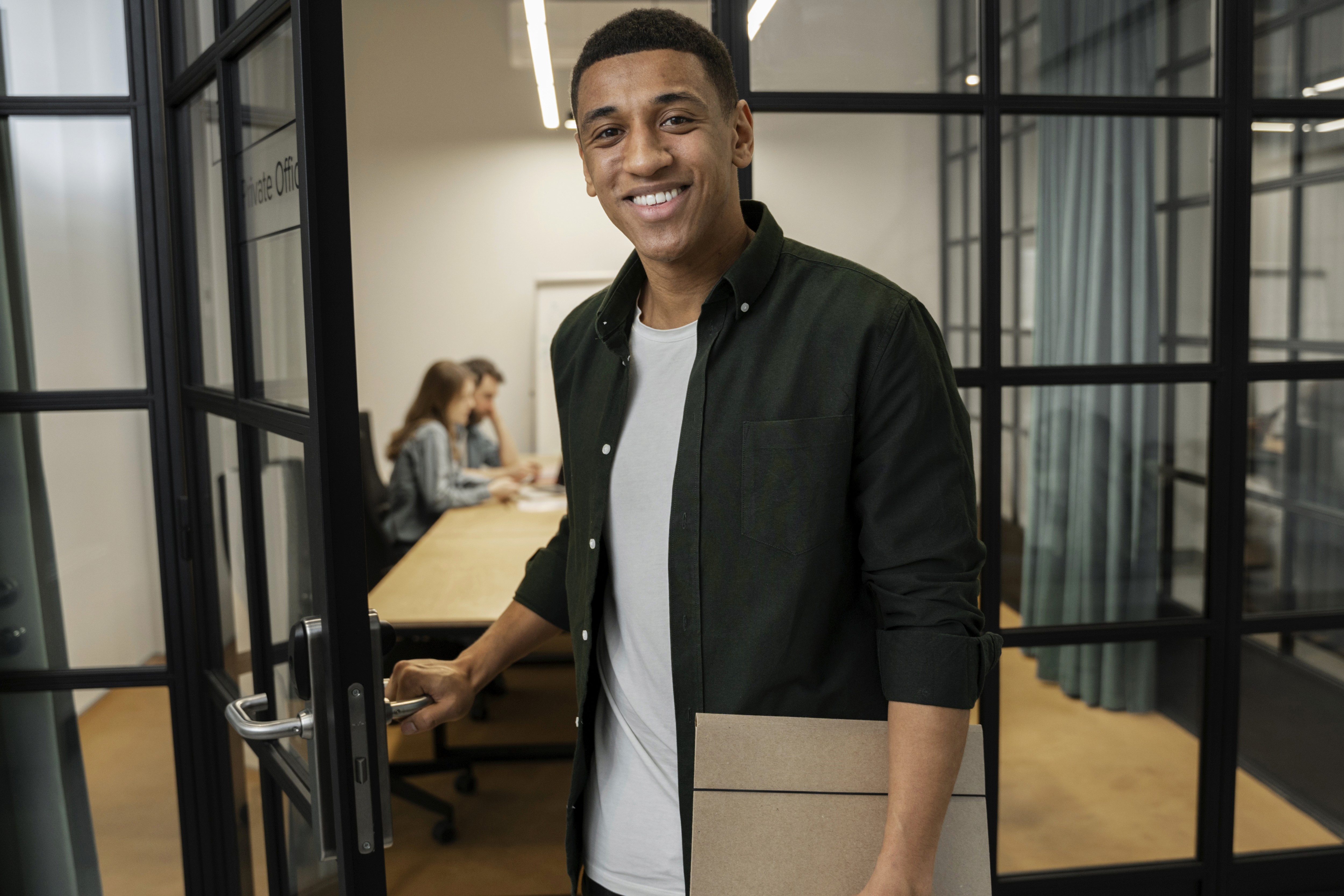 woman holding a phone and man looking at the phone. both are smiling