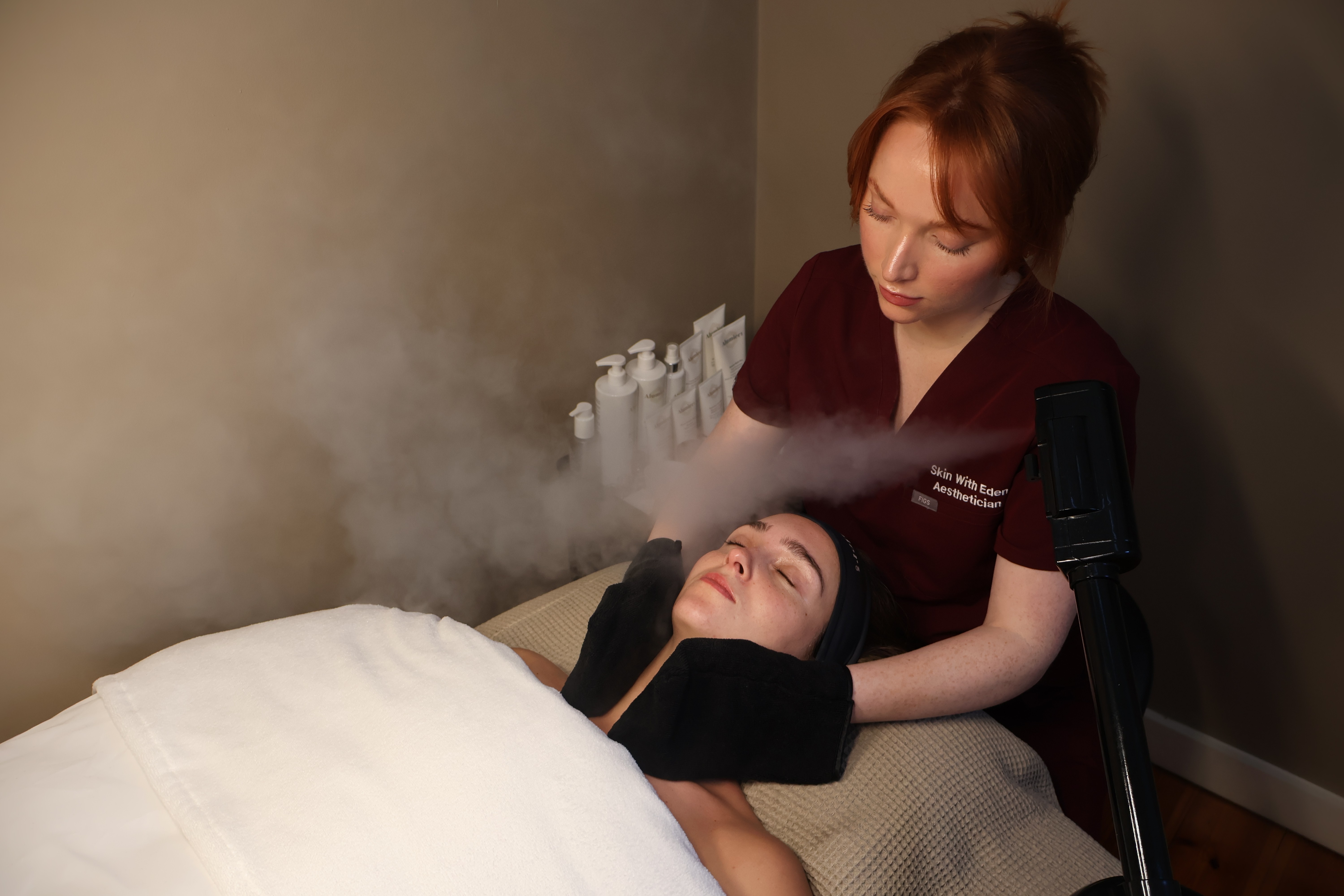 Rachel, personal trainer, looking to the side confidently in a fitness studio