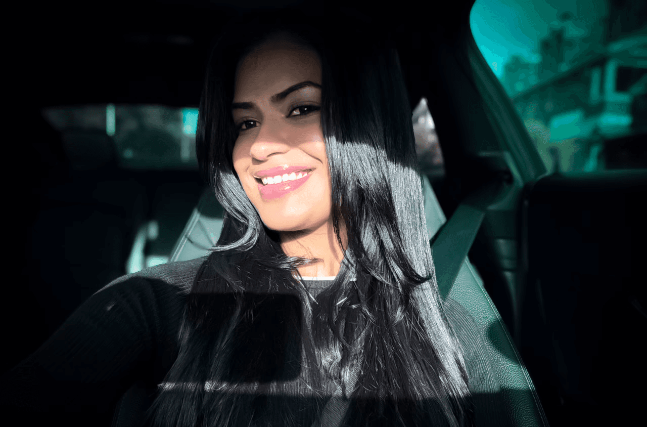 Monochrome product shot: black-capped cosmetic bottle with dynamic water splash on a clean white background.