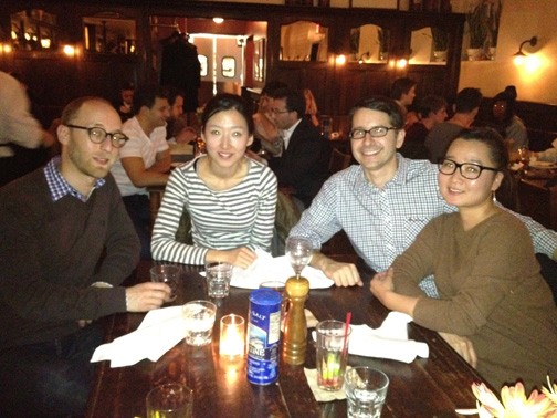 A photo of four people sitting at a table at a restaurant.