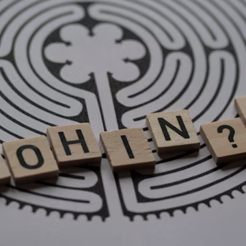 a close up of scrabble tiles with words saying who's in?