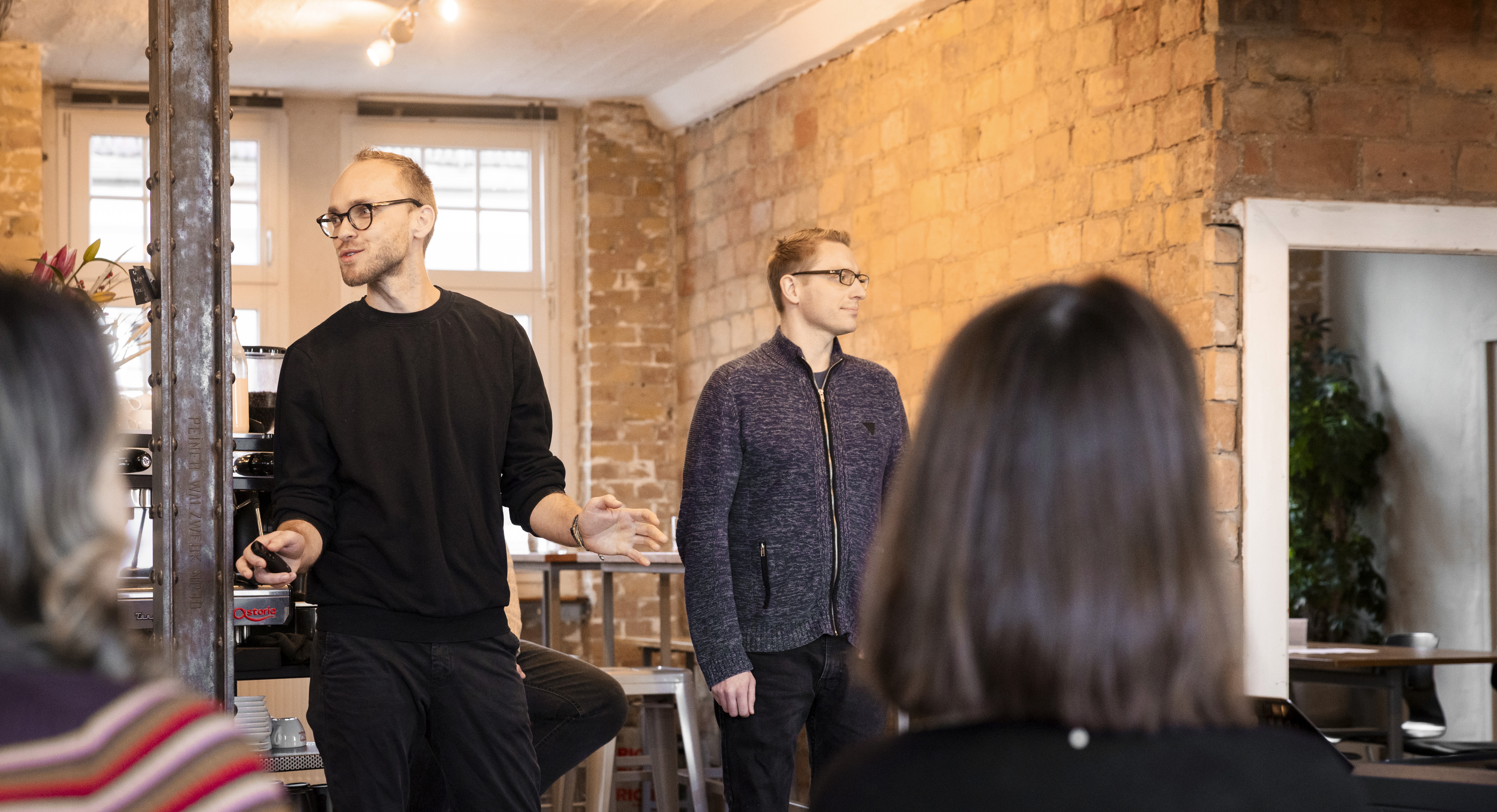 man in blue dress shirt and woman in black long sleeve shirt