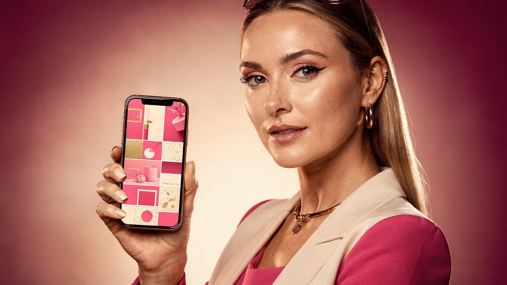 Creator holding a phone showing a cohesive pink-toned feed, consistent ai photos across a feed