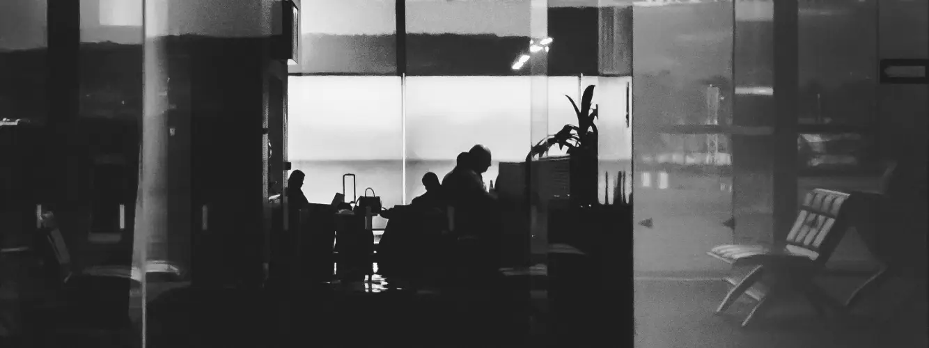 Abstract black and white image with blurred shapes and contrasts, suggesting depth and movement.