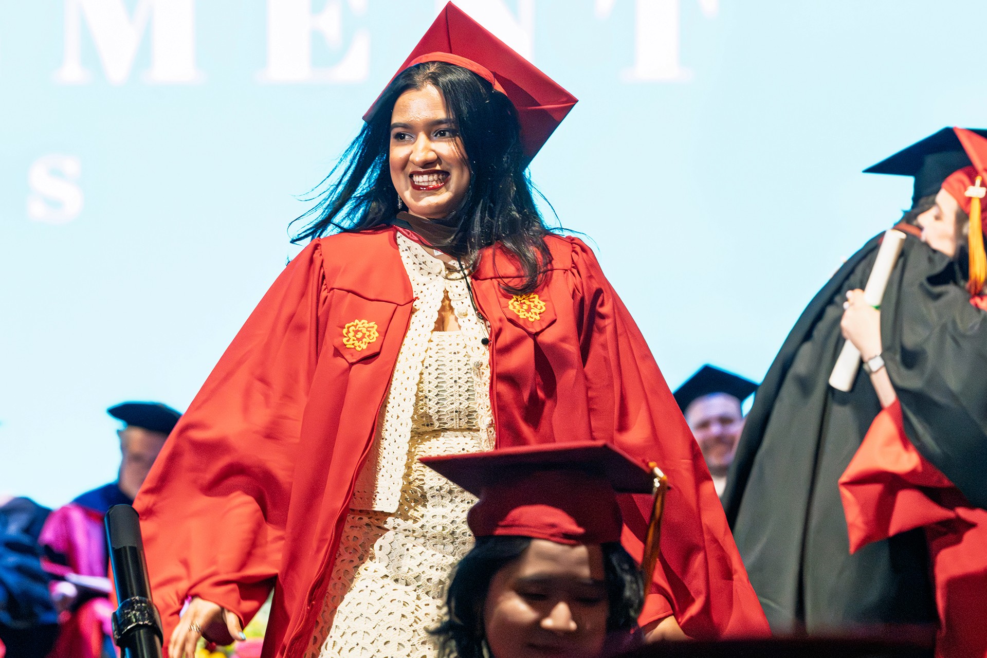 a student on stage getting her diploma