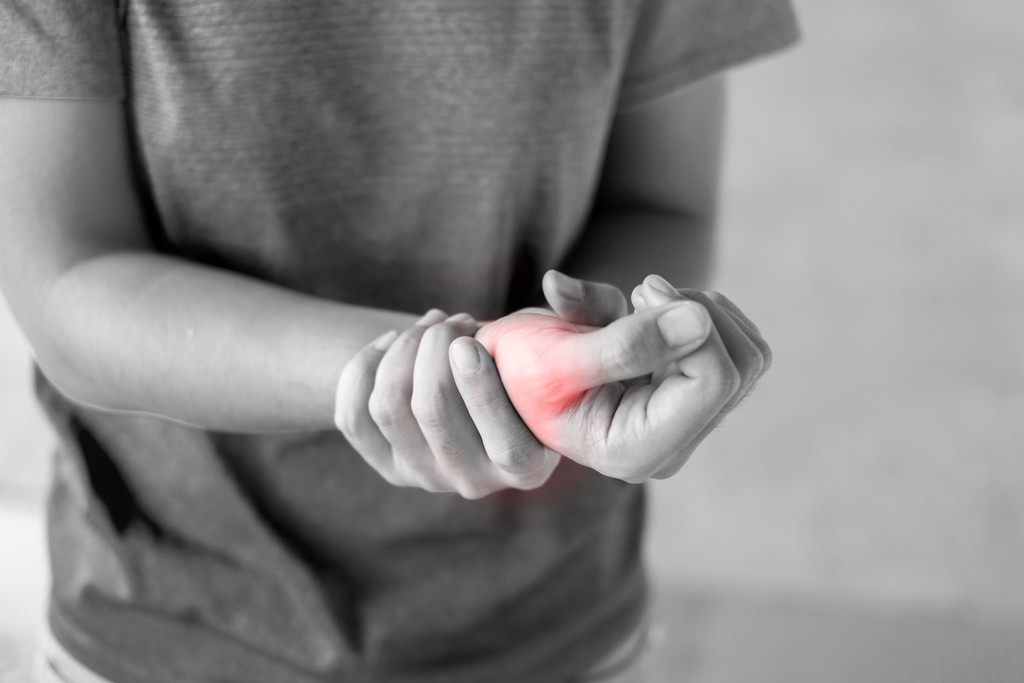 woman holding wrist in pain