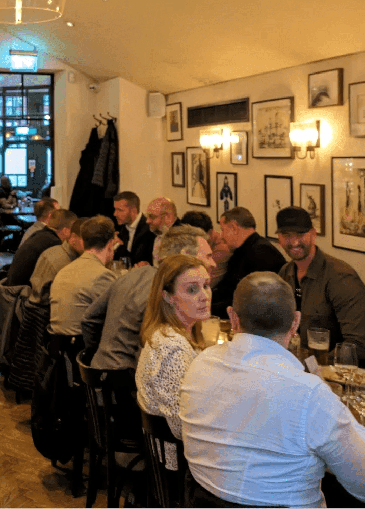A group of people having a discussion over a meal