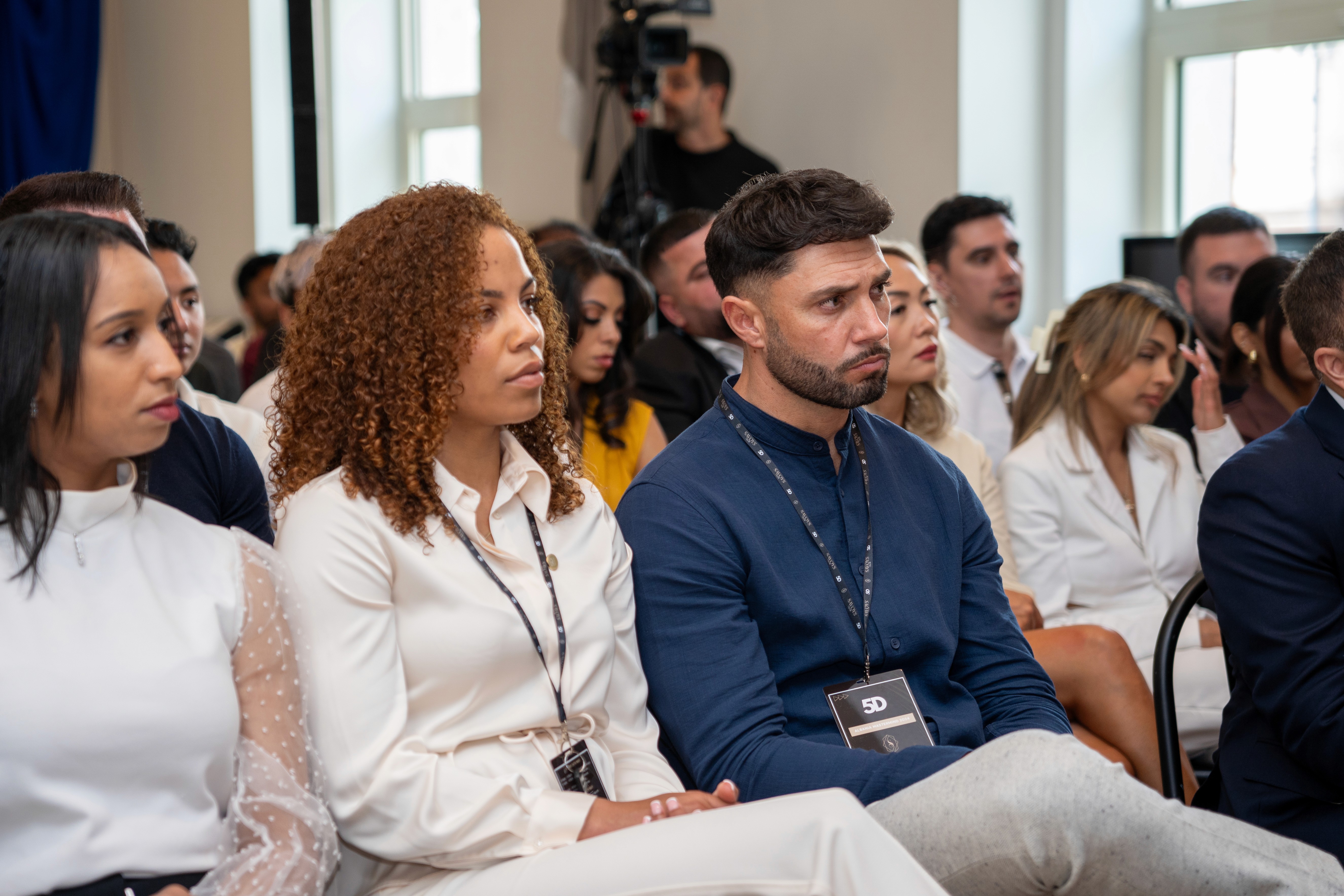 Dee Ludlow listens attentively to a speaker during the National Property Club event, captured by Seven Media while filming and photographing the day’s sessions