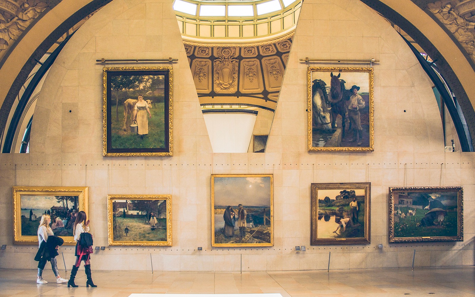 Temporary exhibition paintings at Orsay Museum, Paris, with visitors observing.