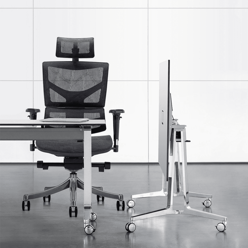 Modern office setup featuring a black mesh ergonomic chair paired with a minimalist white desk and polished metal furniture.