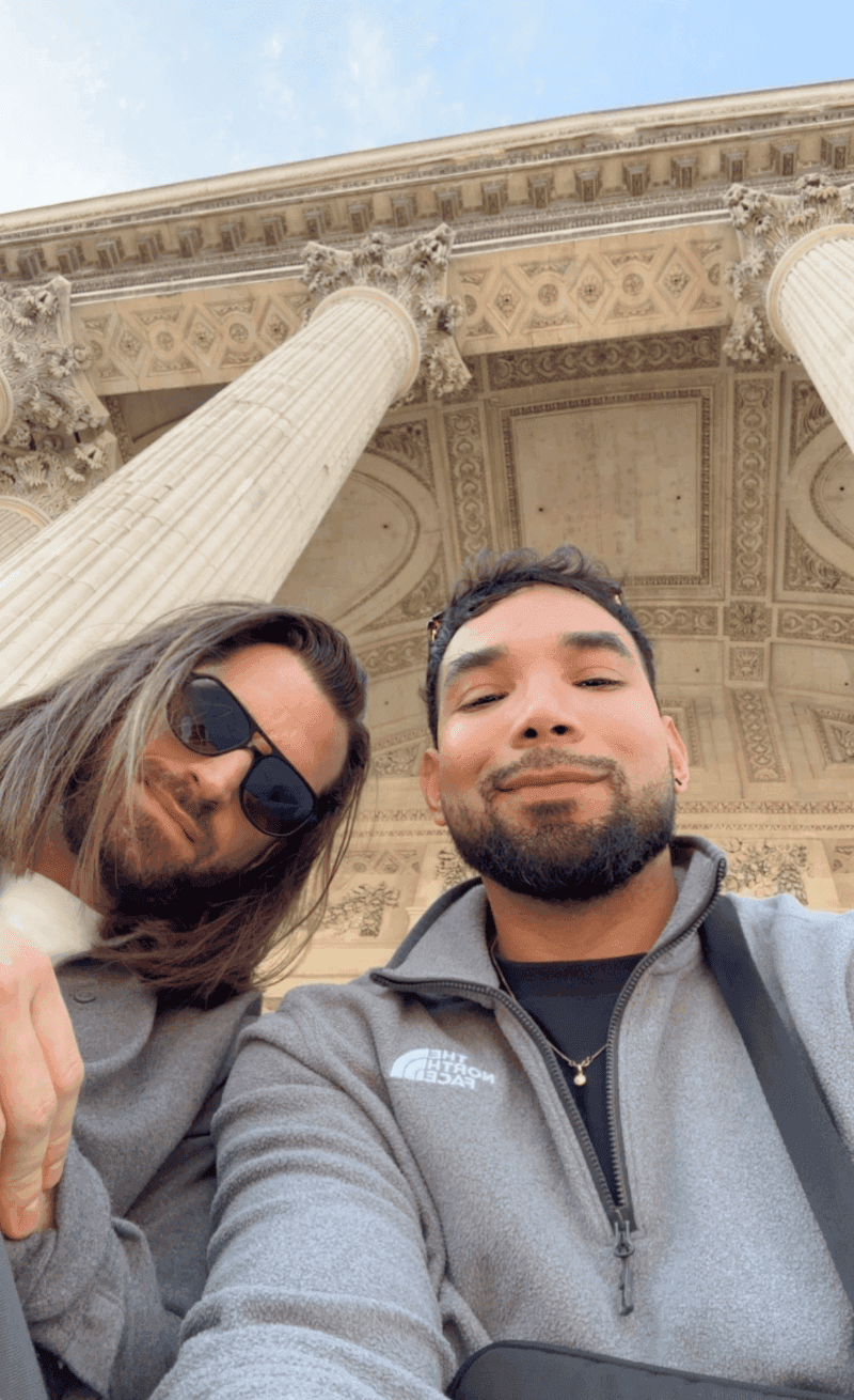 brown wooden lounger near body of water