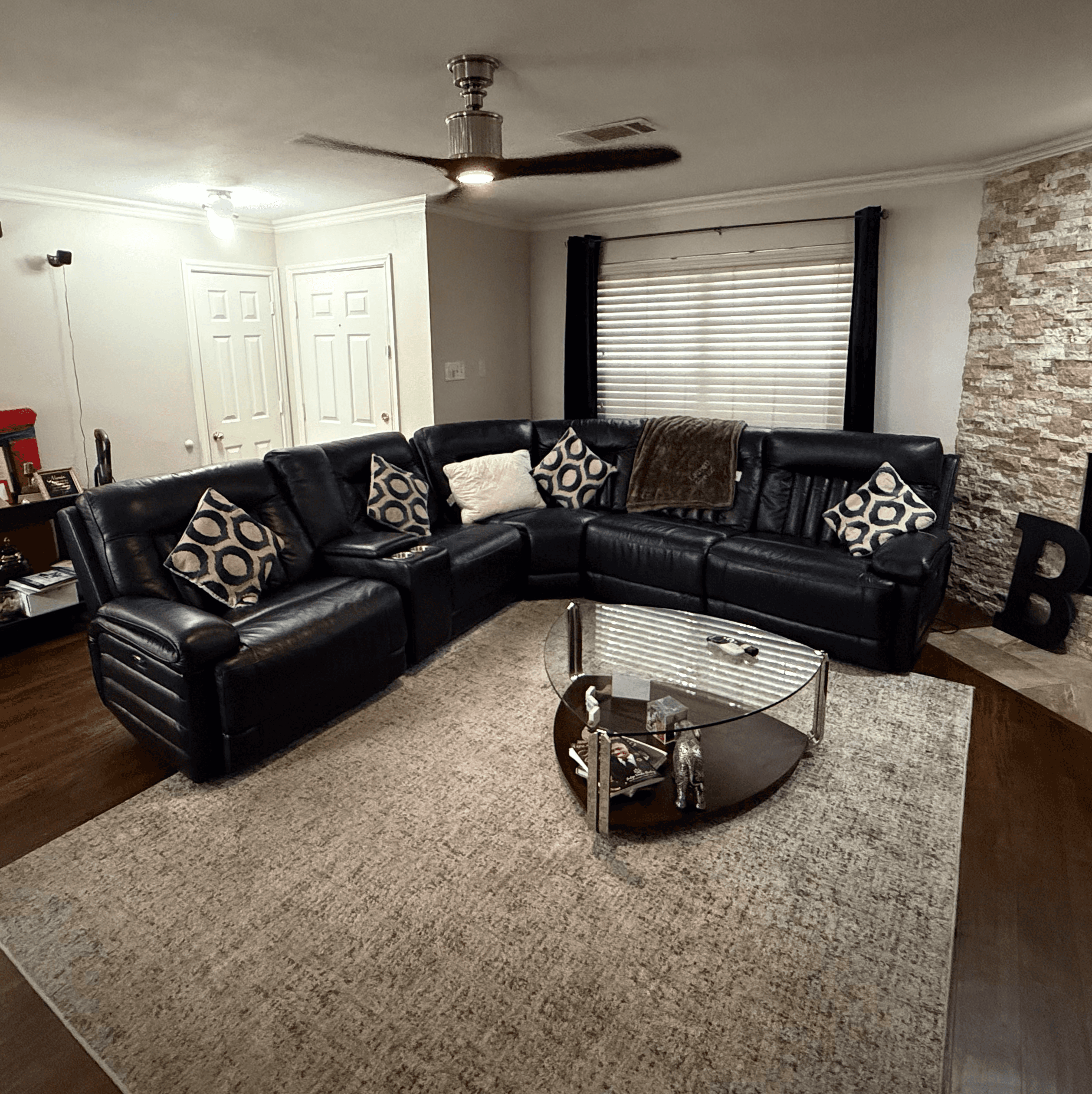 The same living room after cleaning, with clear floors and styled seating