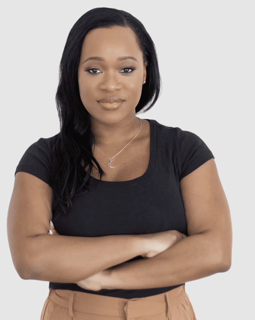 A stylish individual in a cream knit beanie and cardigan, paired with a dark gray shirt, set against a neutral gray background.