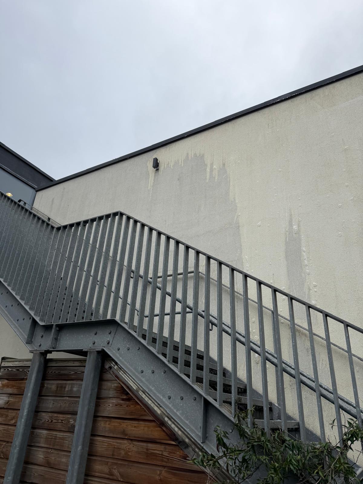 A diverse team collaborates around a table, analyzing documents and charts in a professional setting with a light green background.