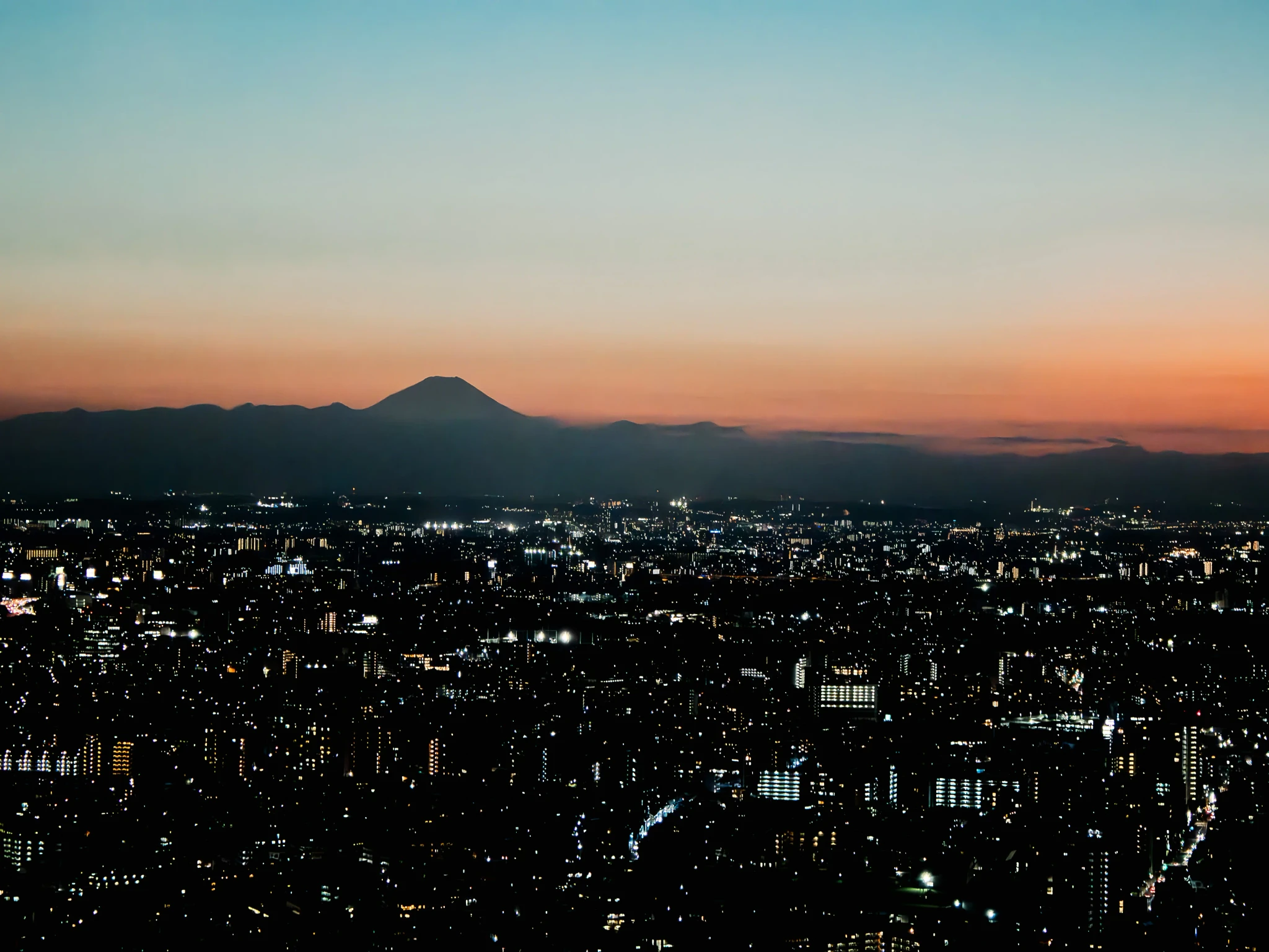 Tokyo at sunset with Mt Fuji at the horizon