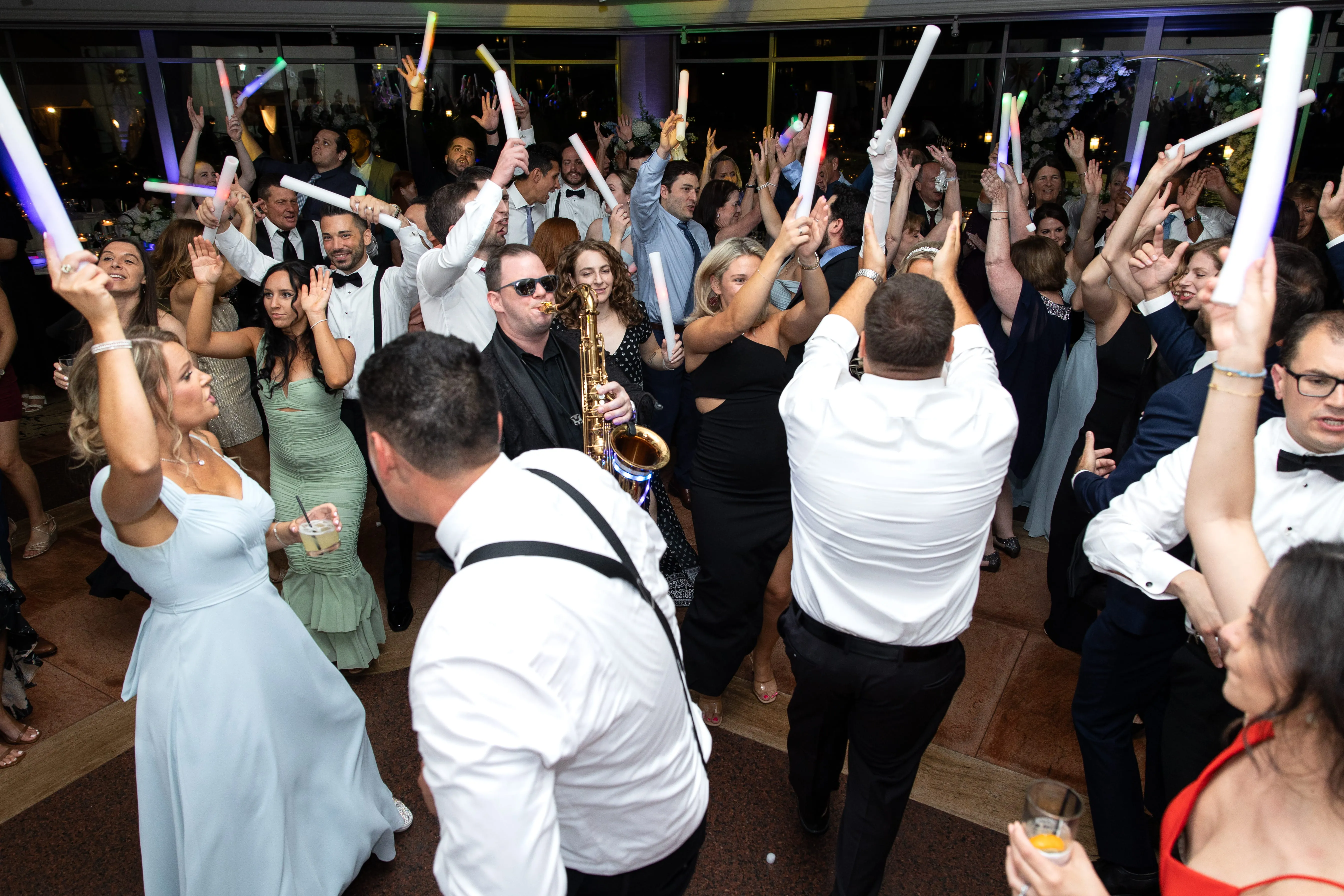 Packed NYC wedding dance floor with guests celebrating high energy reception