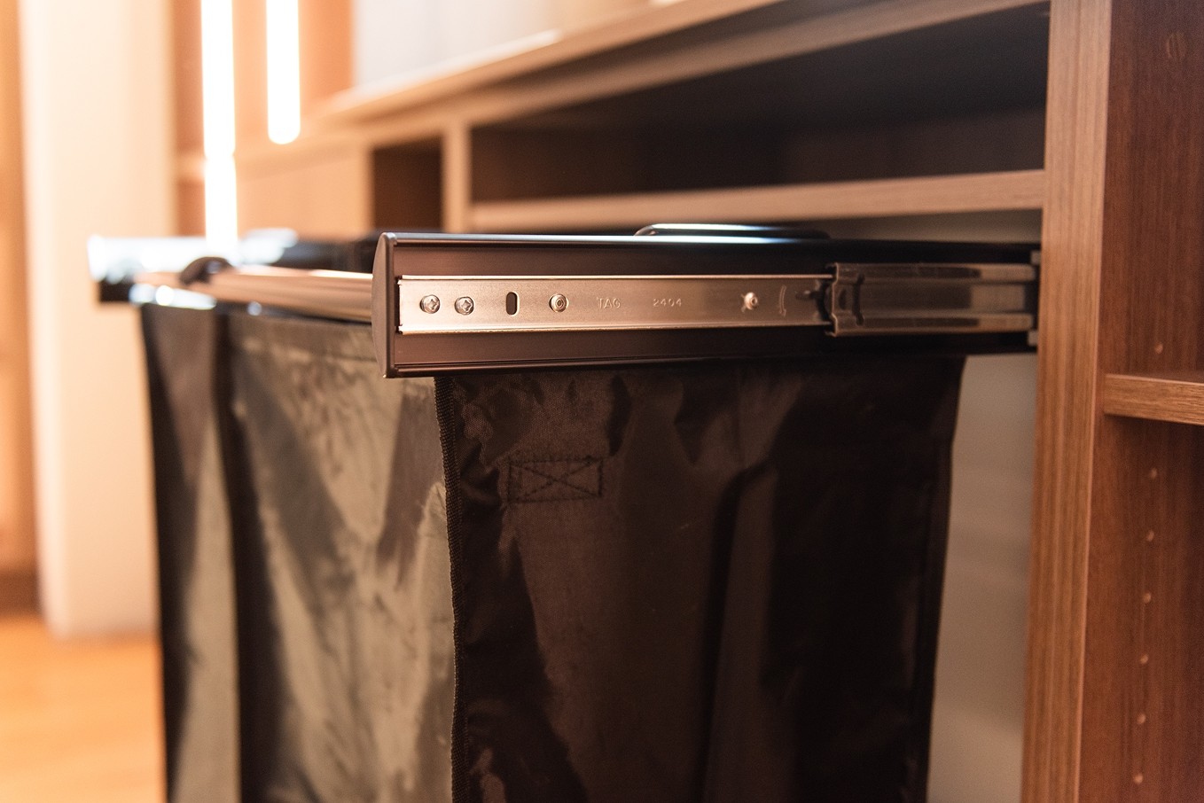 Dual pull-out laundry hampers in lower cabinet