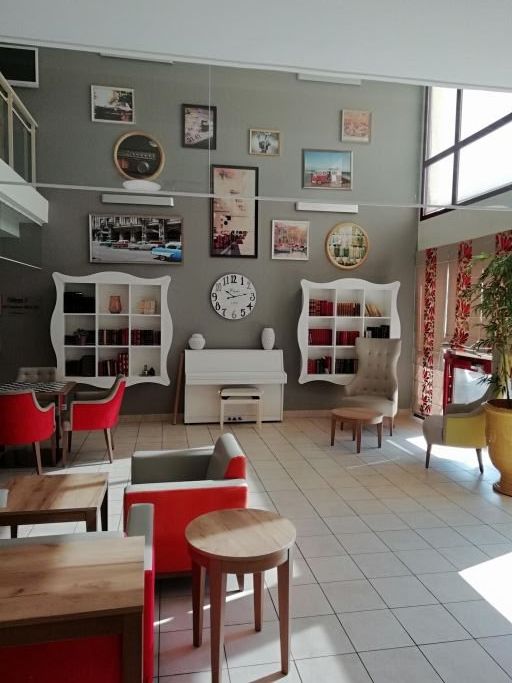 Music room with piano	comfortable seating	and warm natural lighting