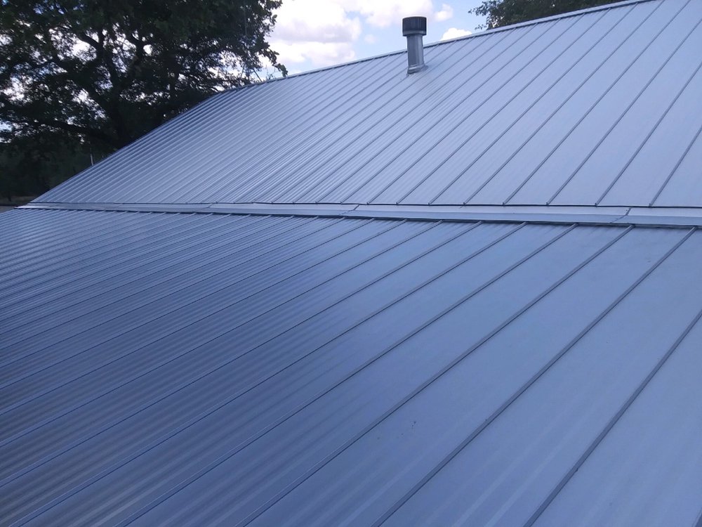 Close-up photo of a Galvalume standing seam roof, showing a pitch change with striations for added texture and aesthetic detail.