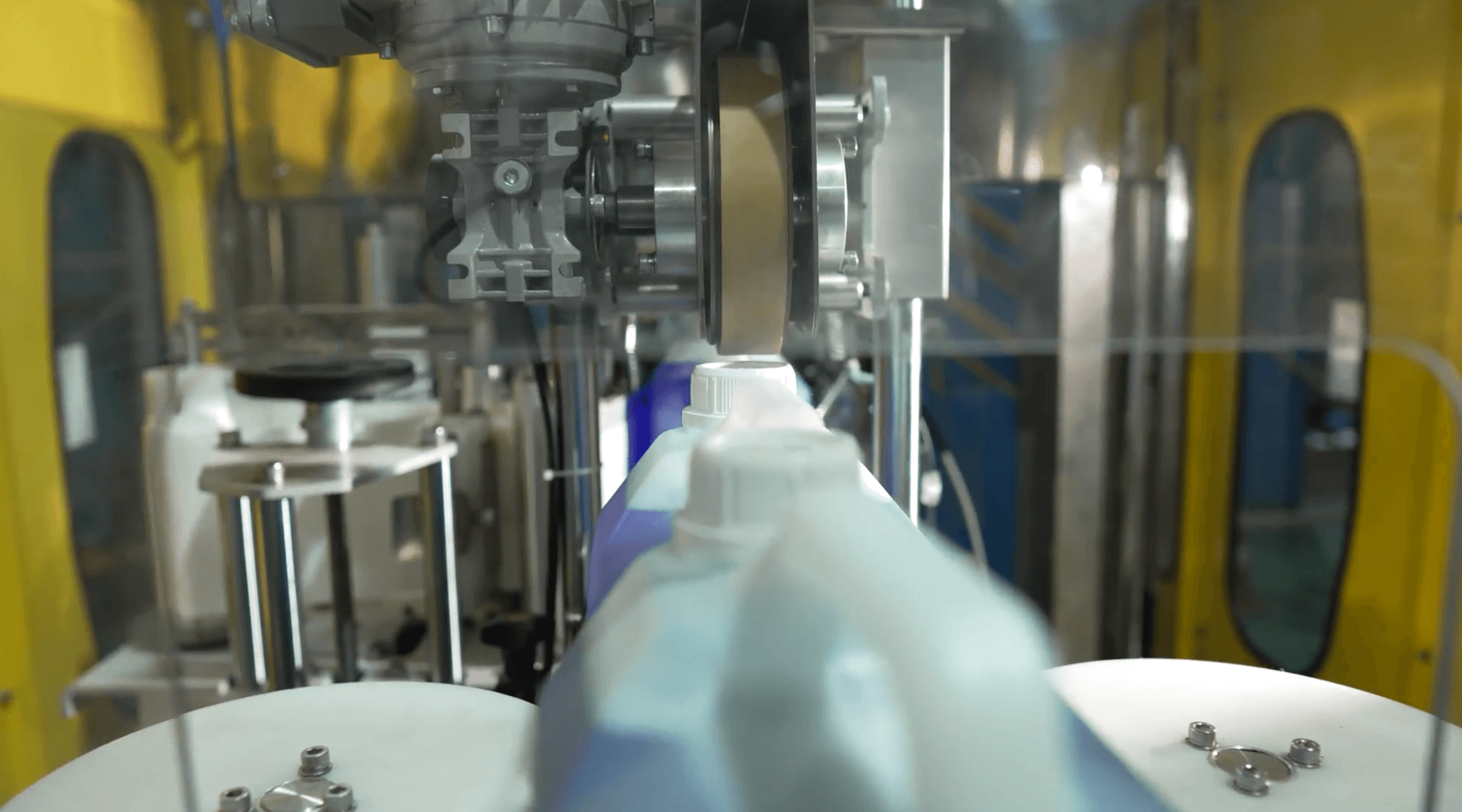A woman in a straw hat stands in the grass