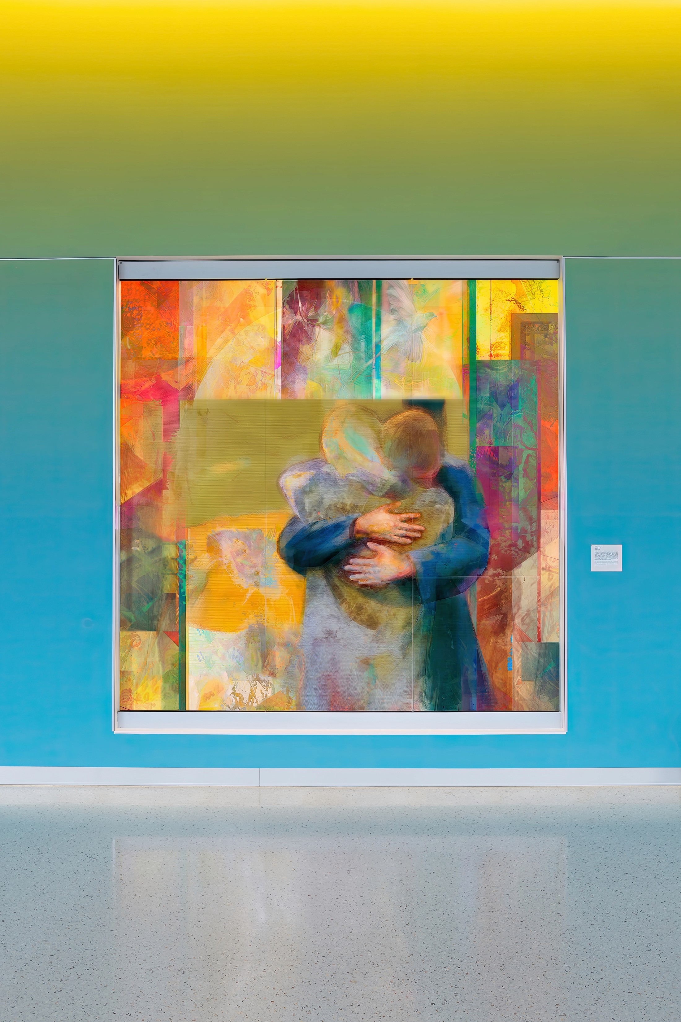 Stained glass window depicting a brother and sister's embrace, Essentia Health St. Mary's Medical Center chapel.