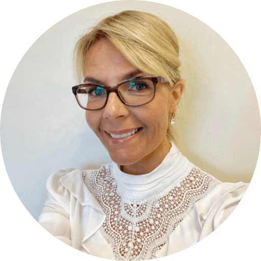 A person in a blue coat smiling