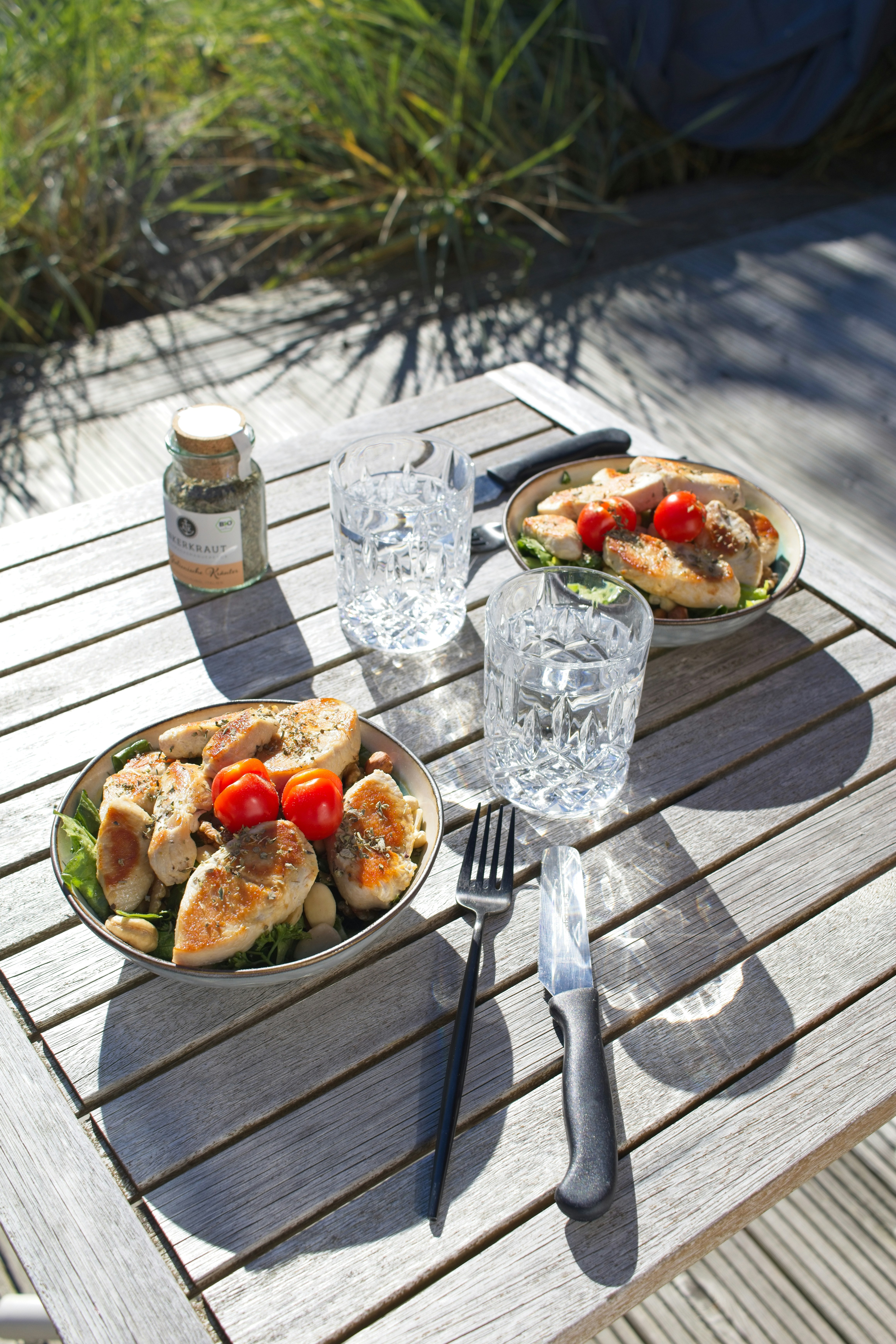 Two plates of food on a wooden table