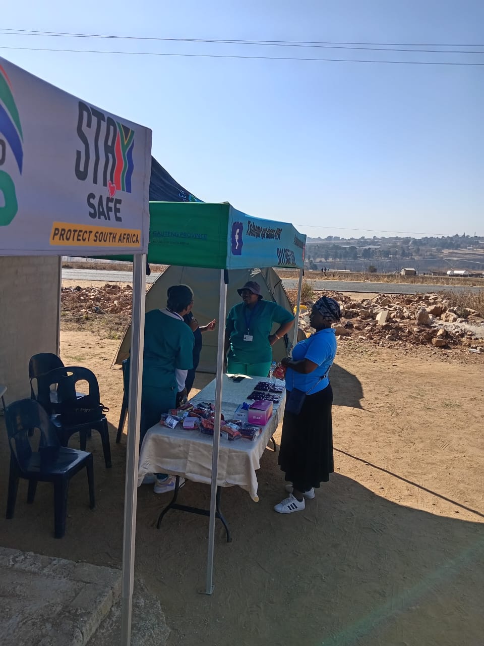 Close-up of a dark green leaf showing its textured surface and central vein against a muted background.