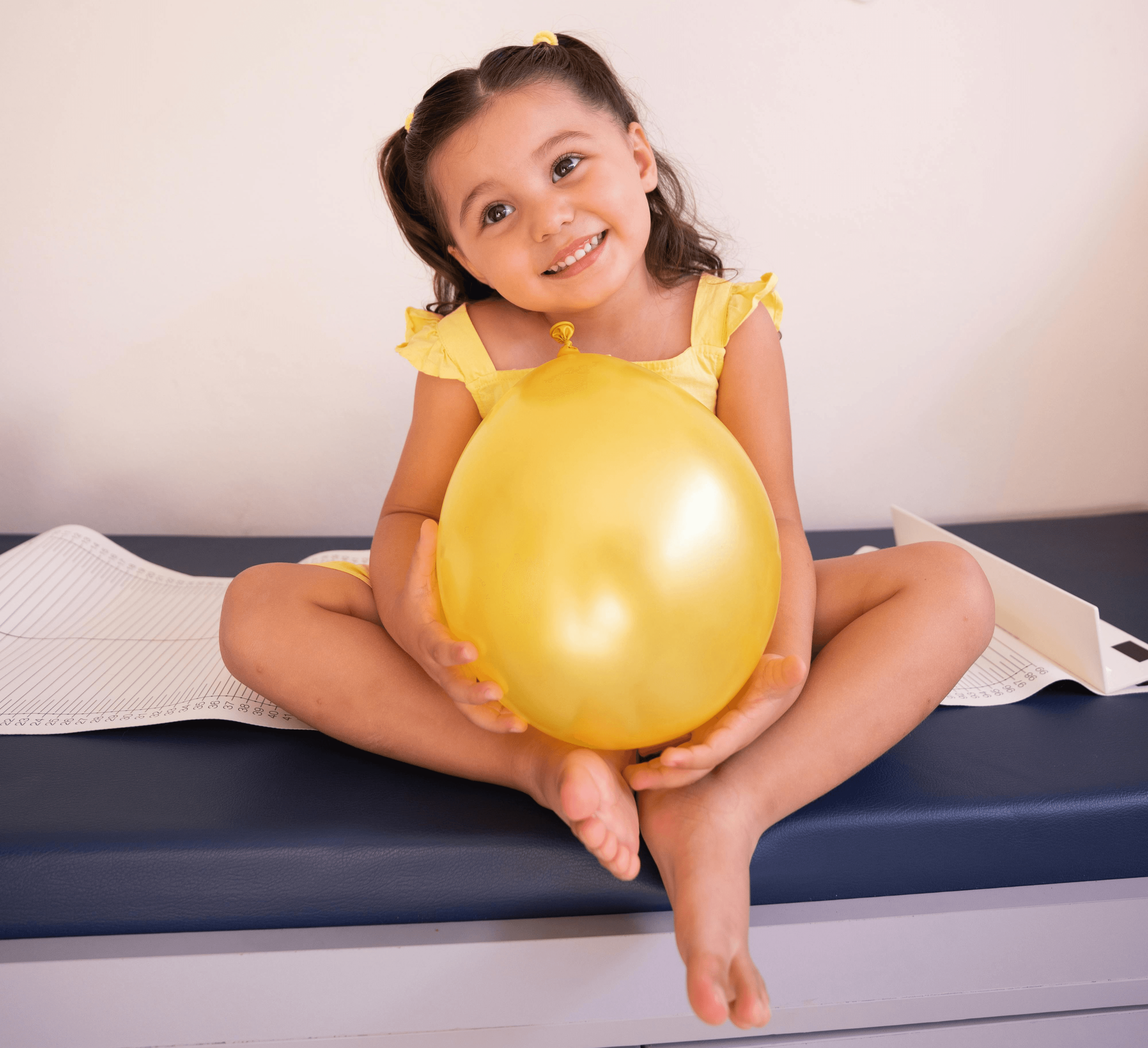 Man holding young girl, who is smiling at the camera