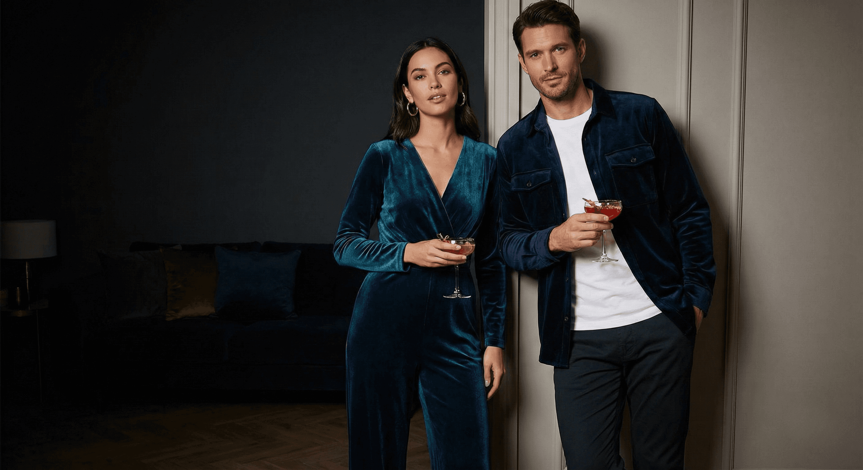 Elegant holiday party outfit featuring navy blue and emarald velvet and silver accessories, offering a refined Christmas look for those searching for stylish options beyond classic red and green outfits.