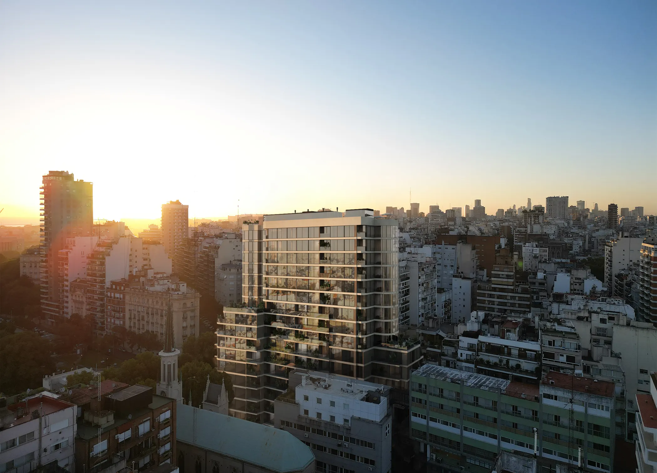 Amanecer sobre una ciudad, con edificios contra un cielo despejado y luz suave iluminando el horizonte.