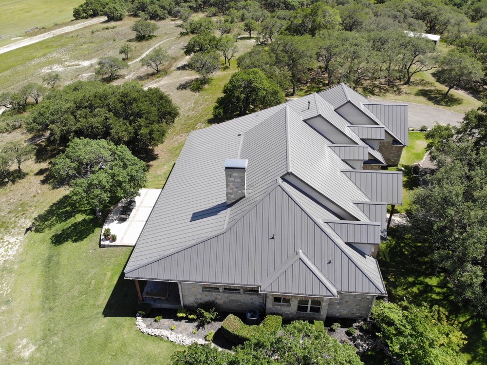 A sleek standing seam 24-gauge charcoal galvalume roof with clean lines and a durable, flat finish.