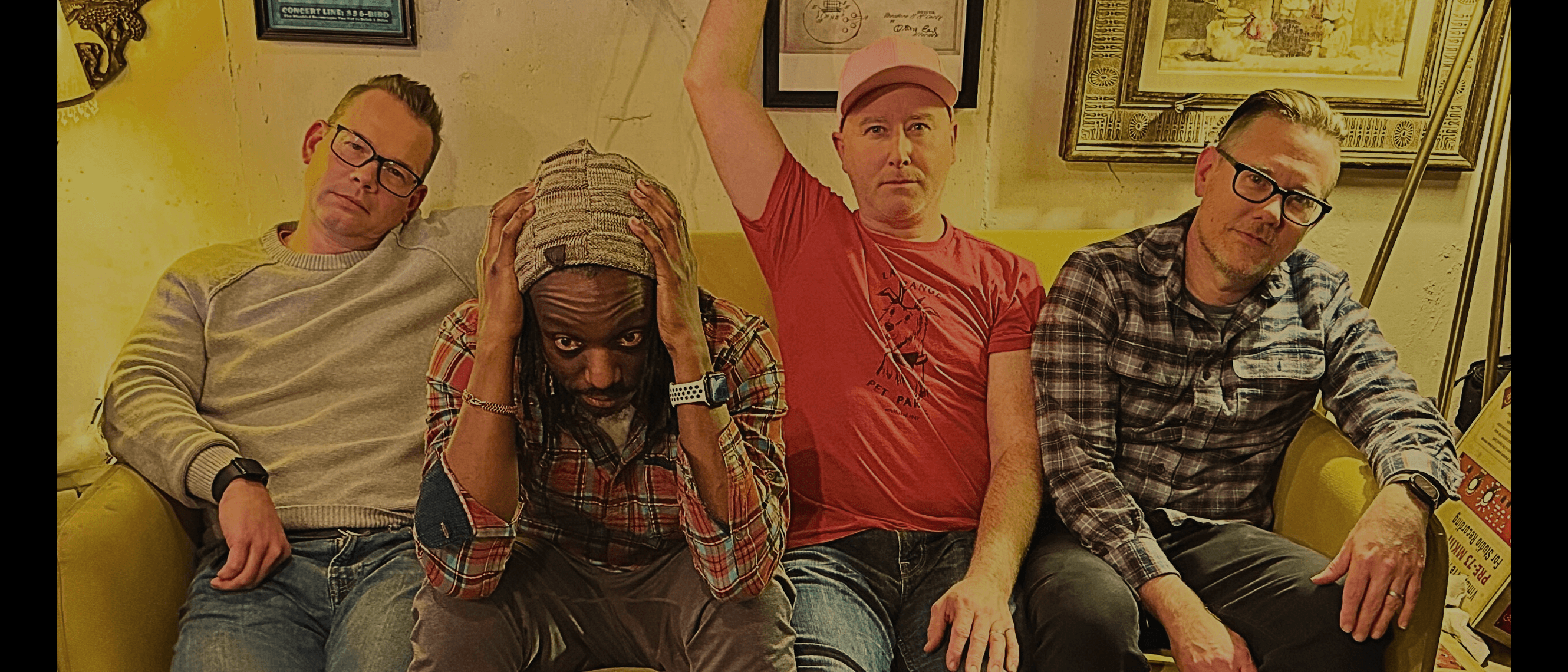 Tree branches reach towards a clear, blue sky.