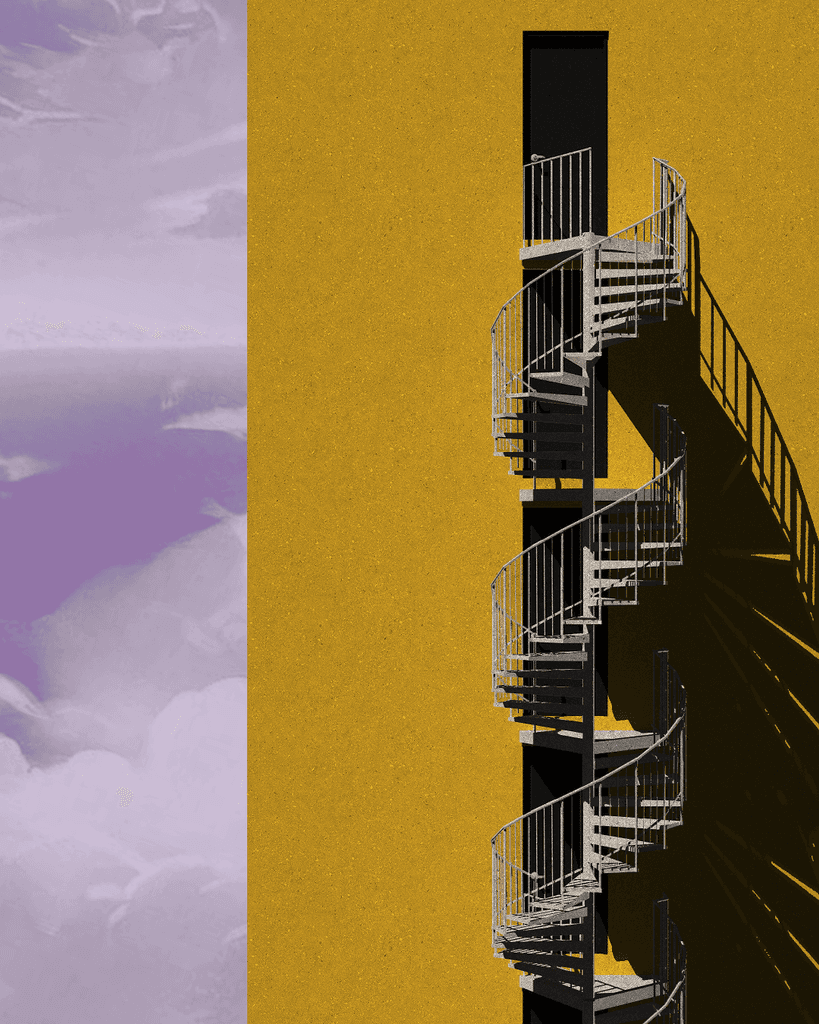 A spiral staircase outside a yellow building