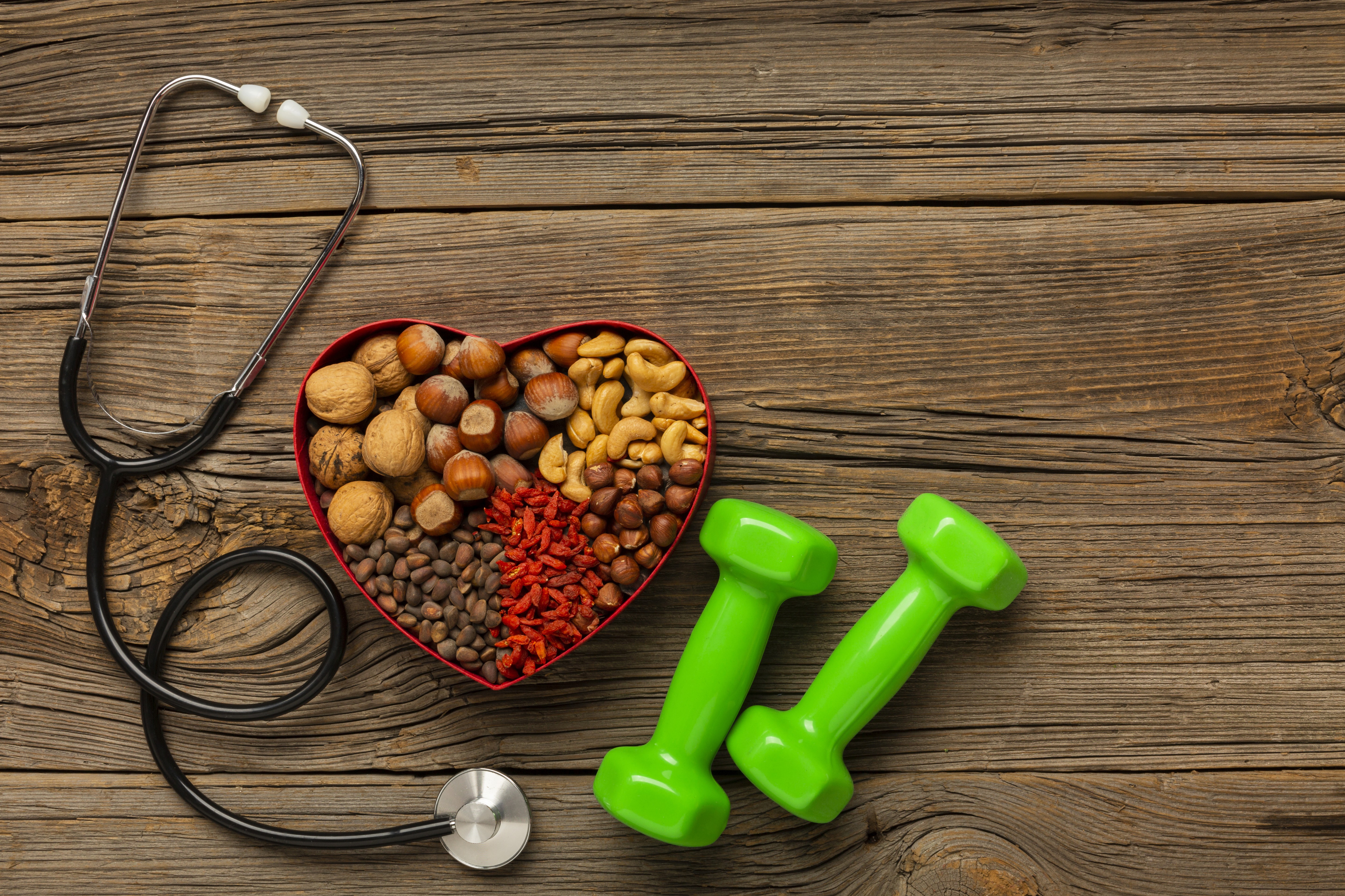 Athletic man in a sleeveless black outfit posing confidently outdoors under a bright blue sky, with a close-up of navy and salmon-colored men’s running shoes in the foreground.