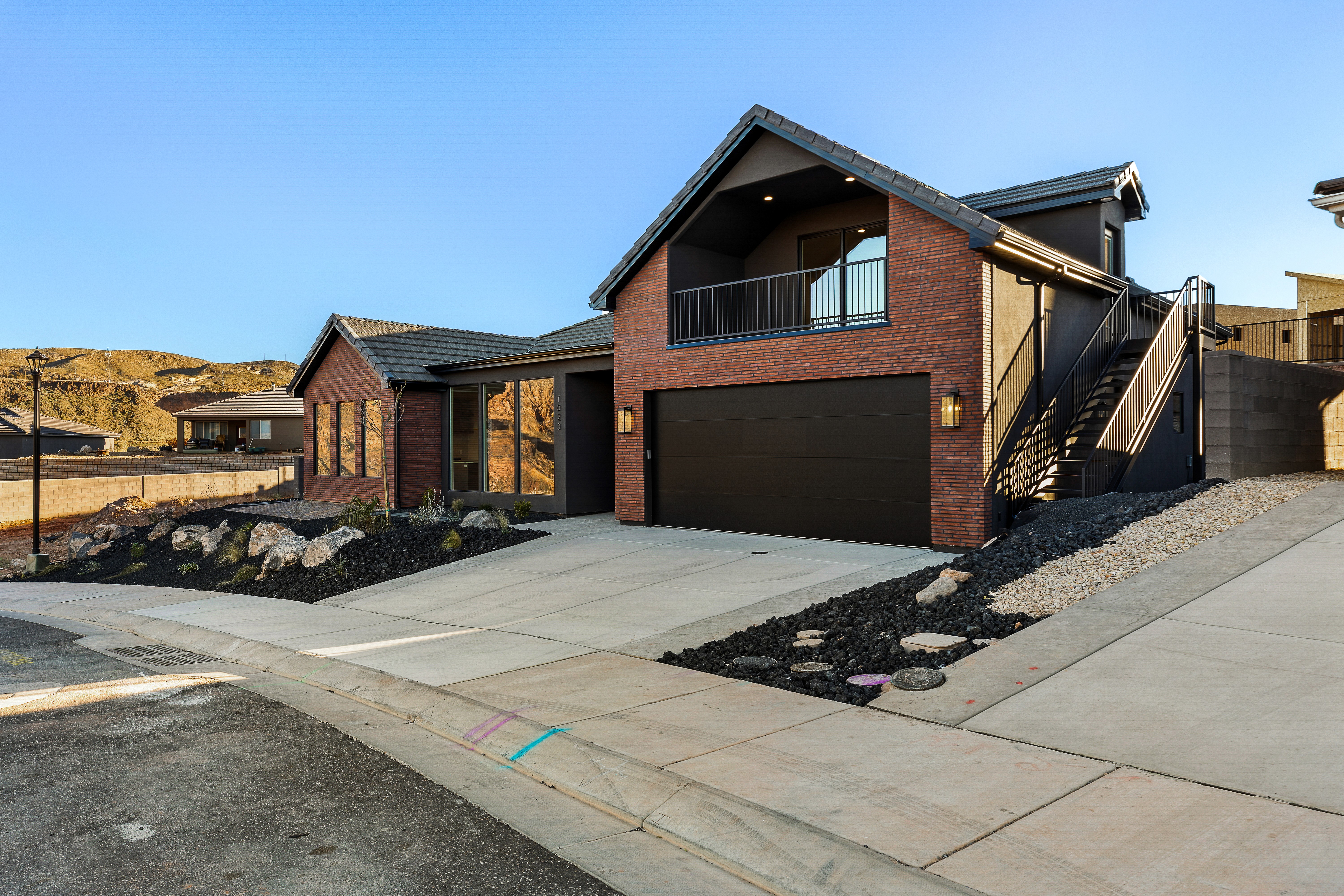 Front exterior of a custom home in Hurricane Utah with modern brick and metal detailing