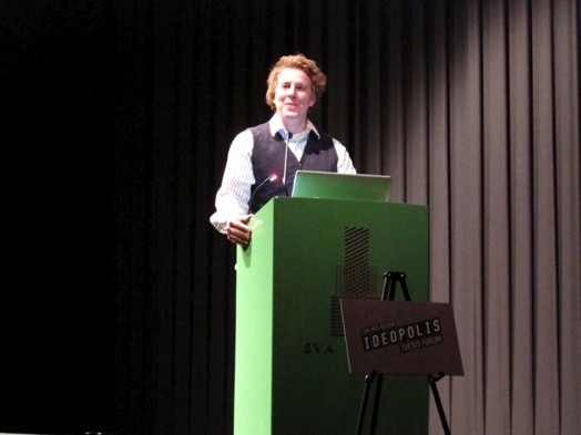 a male student is giving a speech on a stand