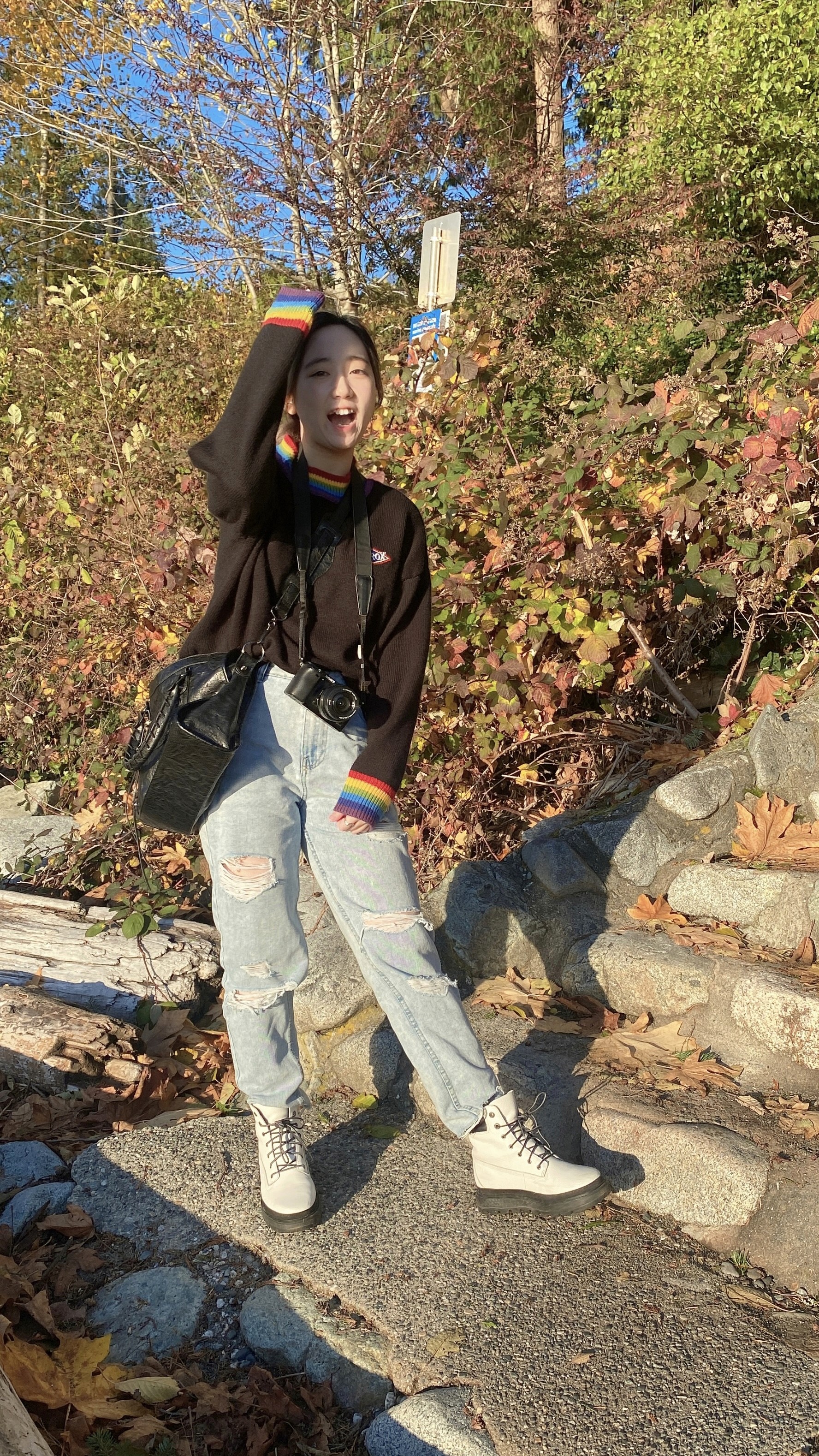Portrait of a laughing person with curly hair wearing a white shirt