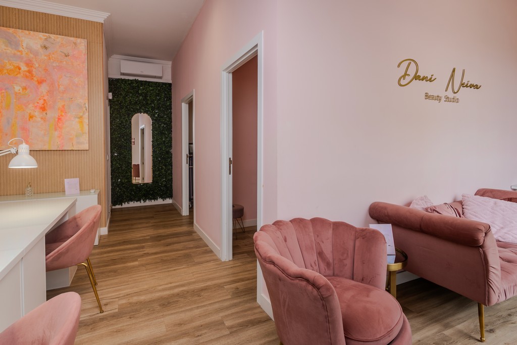 A woman lying down on a soft surface with her eyes closed, bathed in warm sunlight filtering through leaves. Her face has a natural glow, reflecting relaxation and tranquility in a serene spa-like setting.