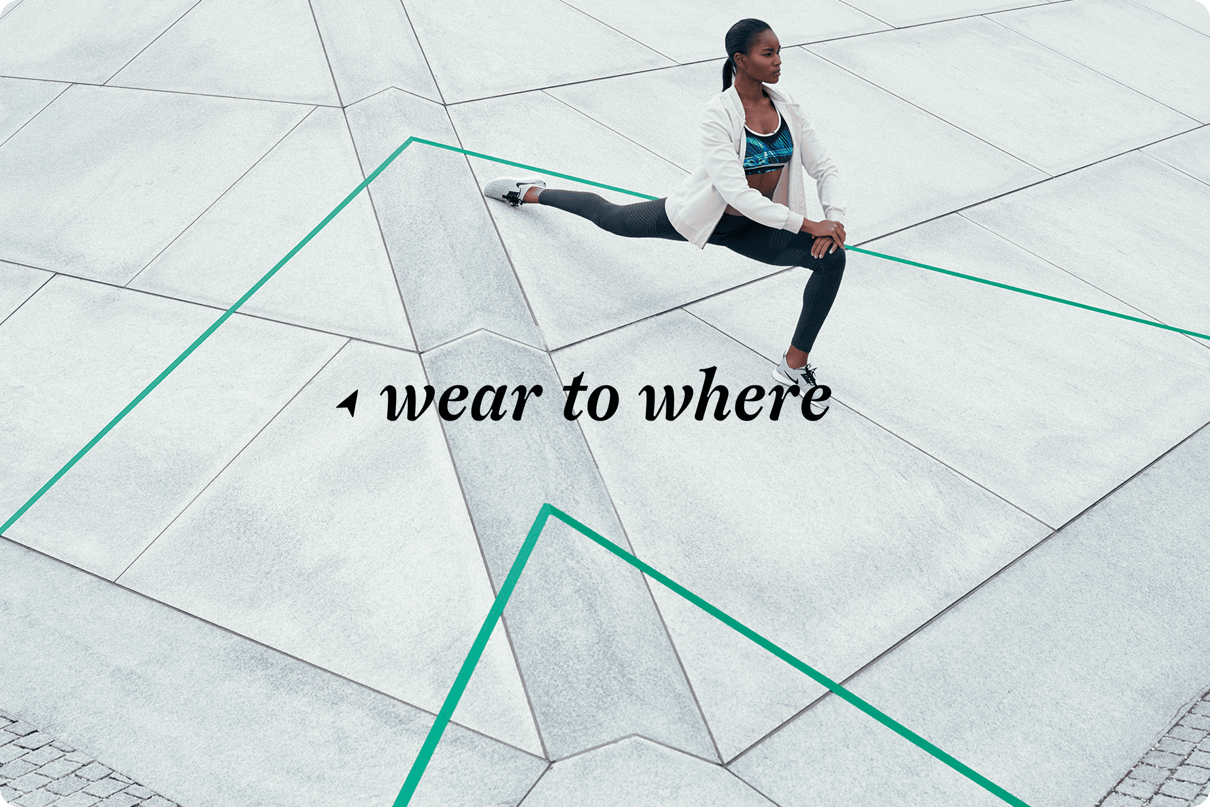 Modern bathroom with geometric patterned floor tile, white freestanding tub, brass fixtures, and white shutters