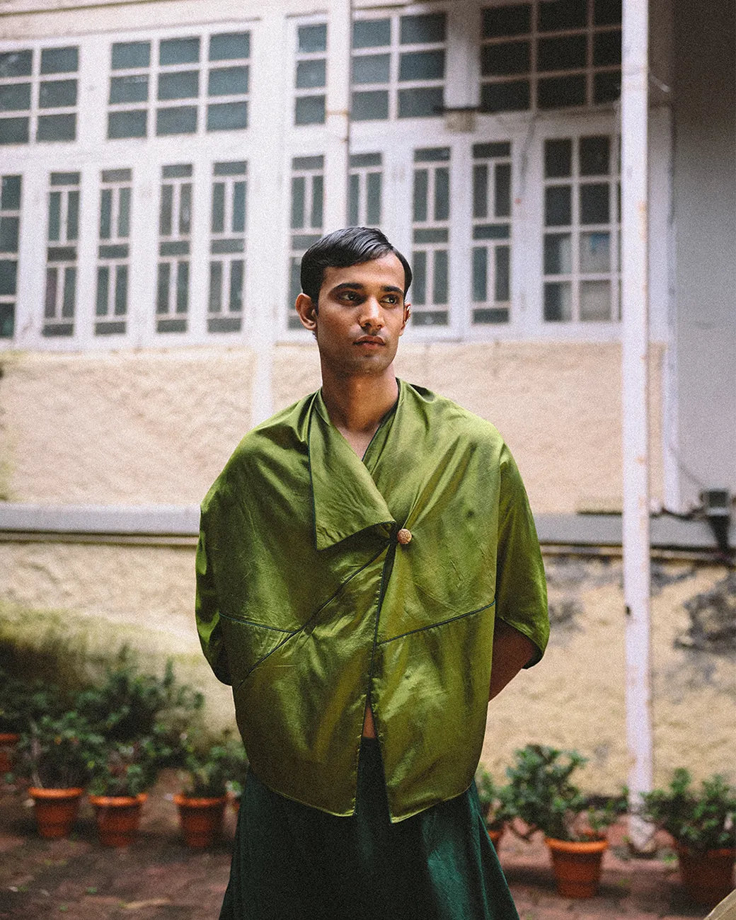 Oversized orange printed silk shirt handcrafted from a vintage sari, featuring a relaxed fit, 3/4 sleeves, soft texture, and playful button details, celebrating comfort, craft, and thoughtful design.