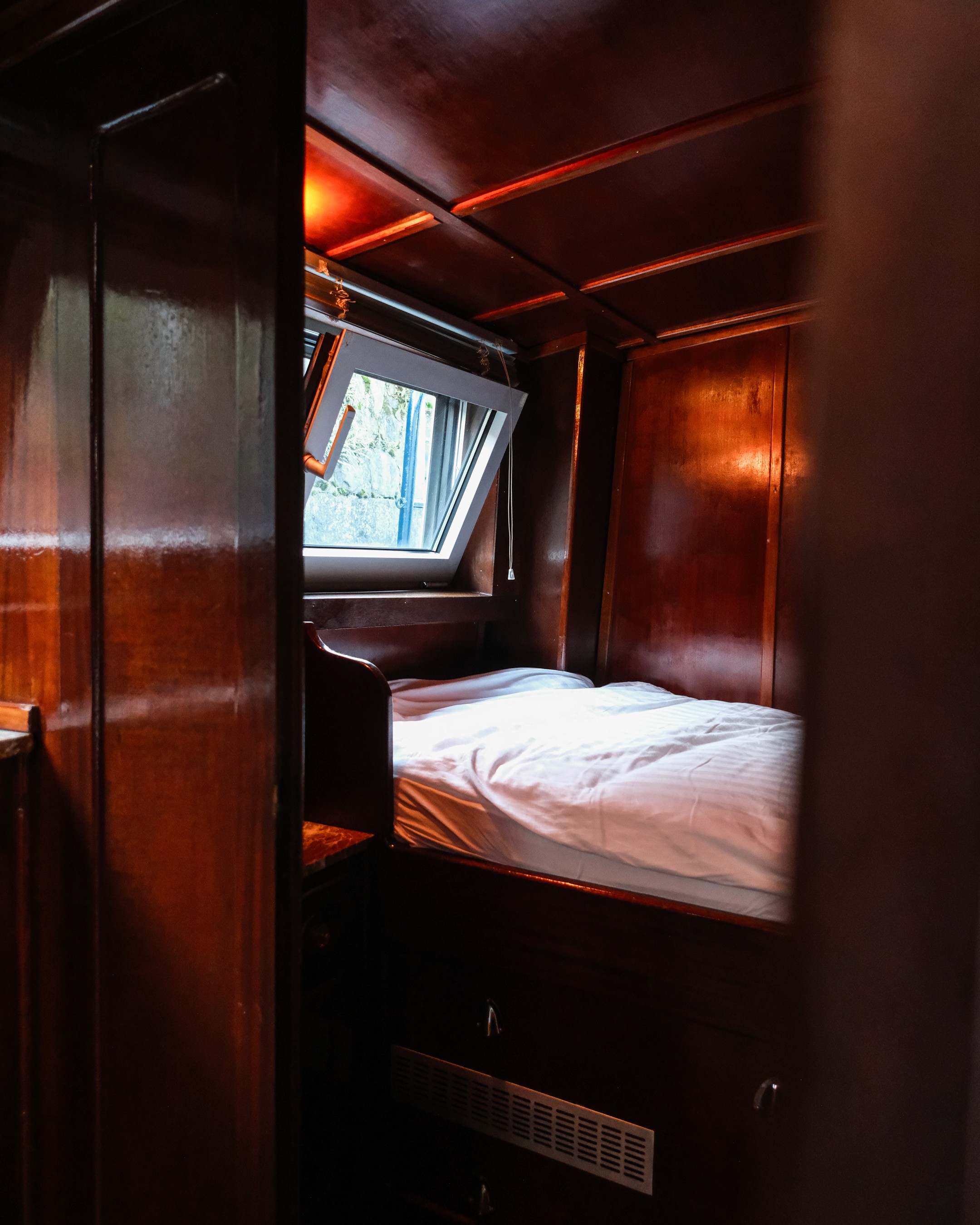 Gray sectional sofa with black coffee table and blue rug